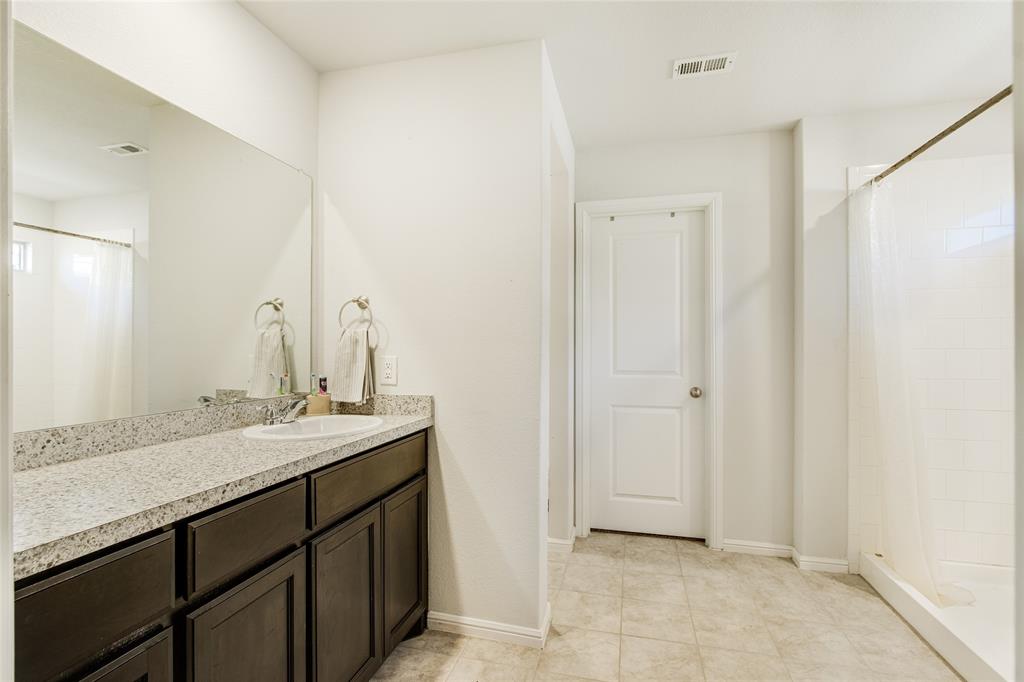 16516 Portage Street Justin, TX 76247 - Photo 18 of 29 a bathroom with a sink and a mirror