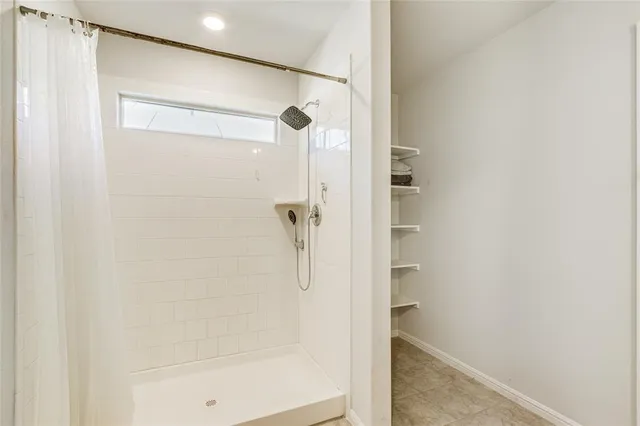 a bathroom with a glass shower door