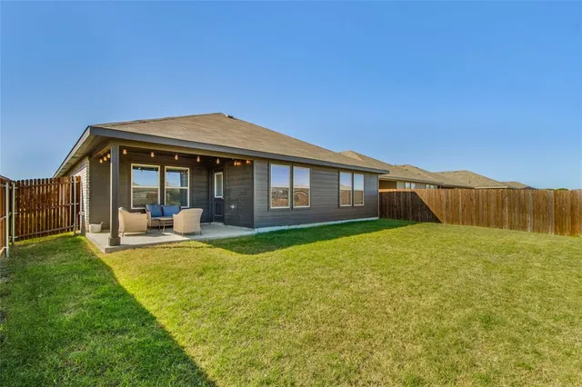 a view of a house with backyard porch and furniture