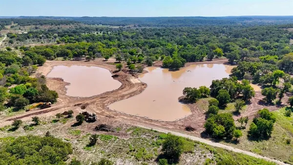 an aerial view of a house with a lake view and mountain view