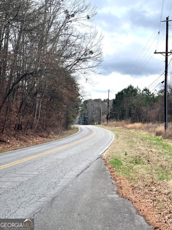 a view of a yard with wooden fence