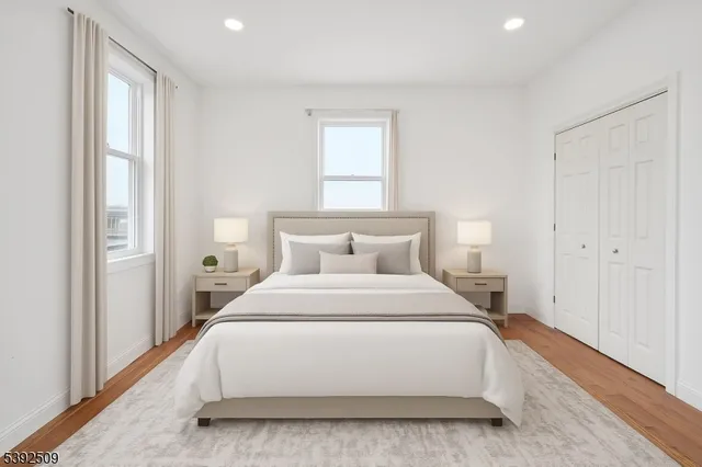 a spacious bedroom with a bed and a window