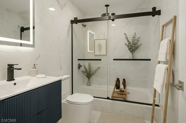 a bathroom with a sink a toilet and a shower