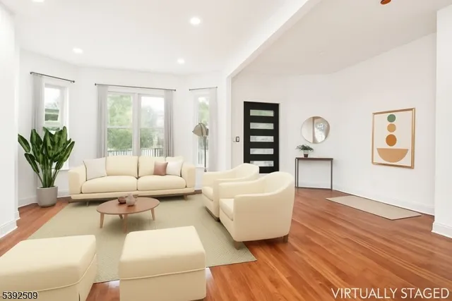 a living room with furniture and wooden floor