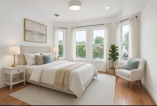 a bedroom with a bed and a large window