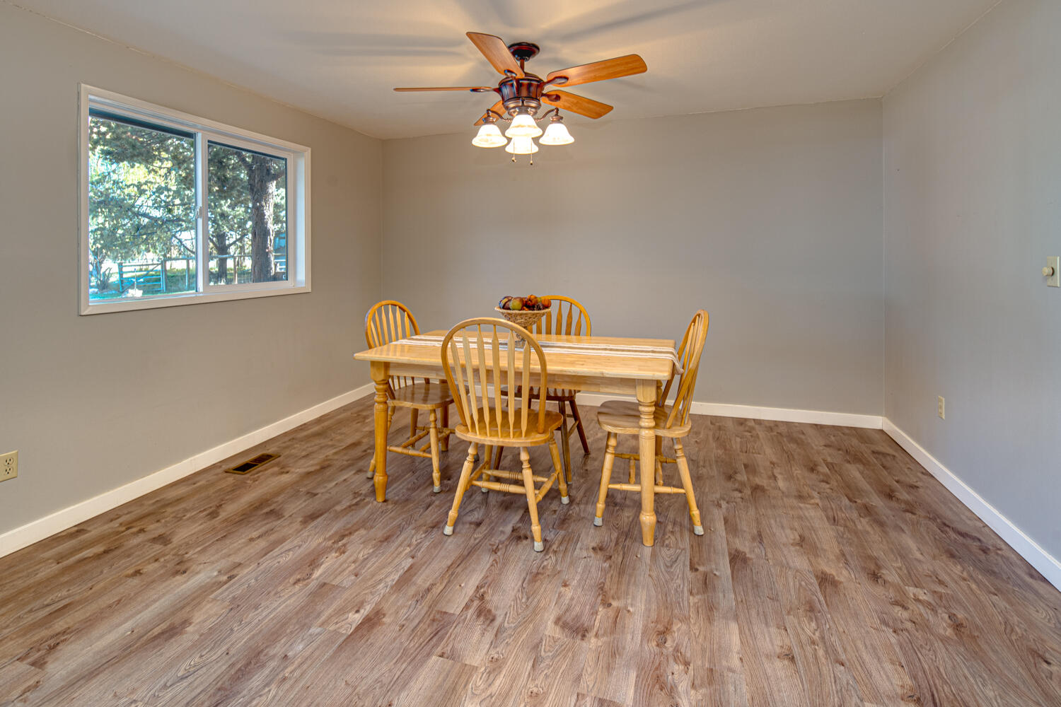 64570 Research Road Bend, OR 97703 - Photo 12 of 60 a dining room with furniture a chandelier and wooden floor