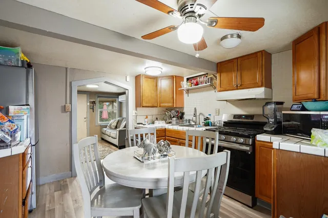 a kitchen that has a table and chairs in it