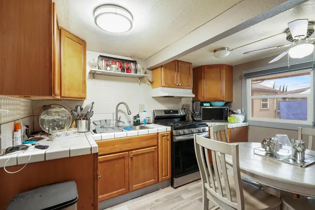a kitchen with a sink stove and cabinets