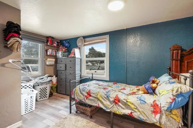 a bedroom that has a bed in it and a large window