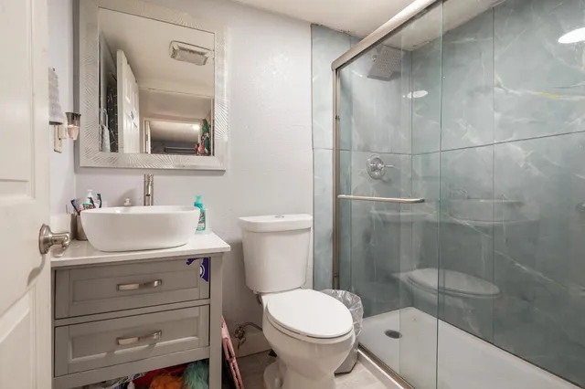 a bathroom with a sink toilet and shower