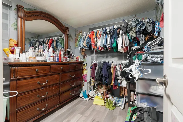 a view of walk in closet with clothes