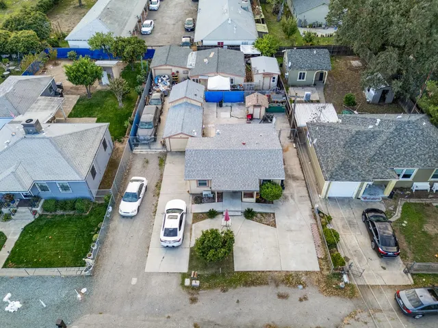 an aerial view of residential houses with outdoor space