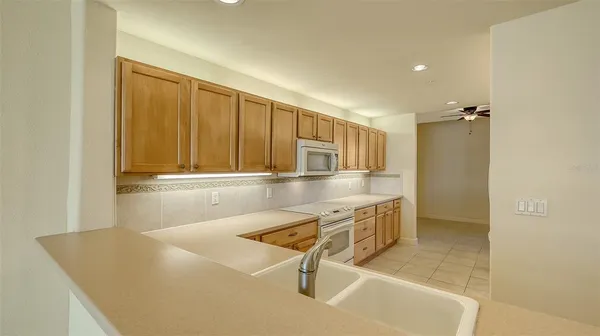 an empty room with window and ceiling fan