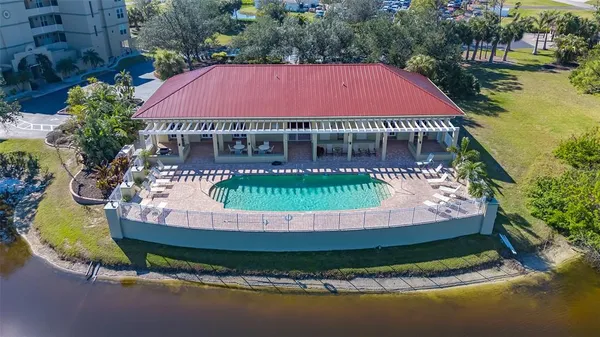 a view of a house with a big yard and a large tree