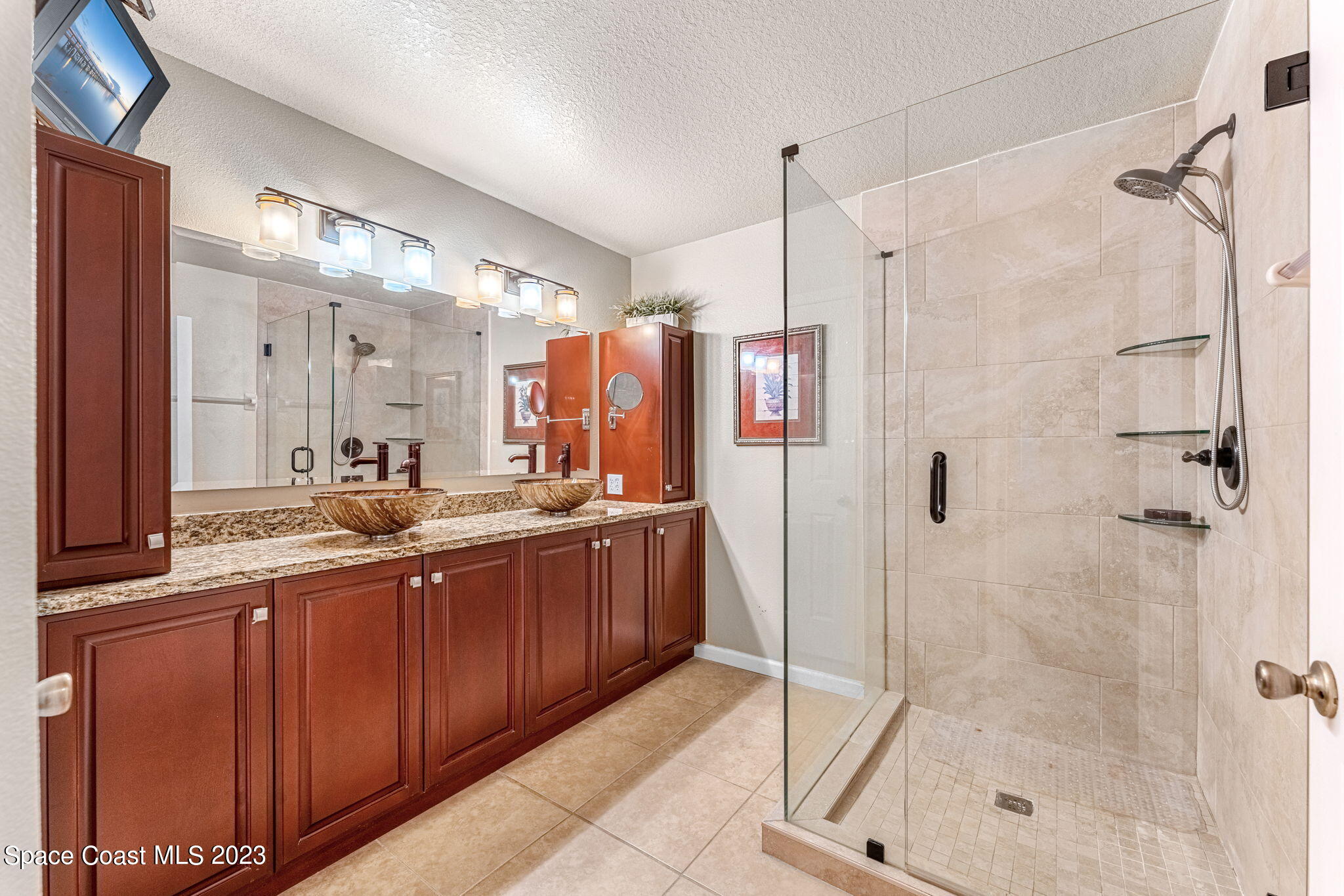 3310 Titanic Circle Indialantic, FL 32903 - Photo 11 of 25 a bathroom with a double vanity sink mirror and shower