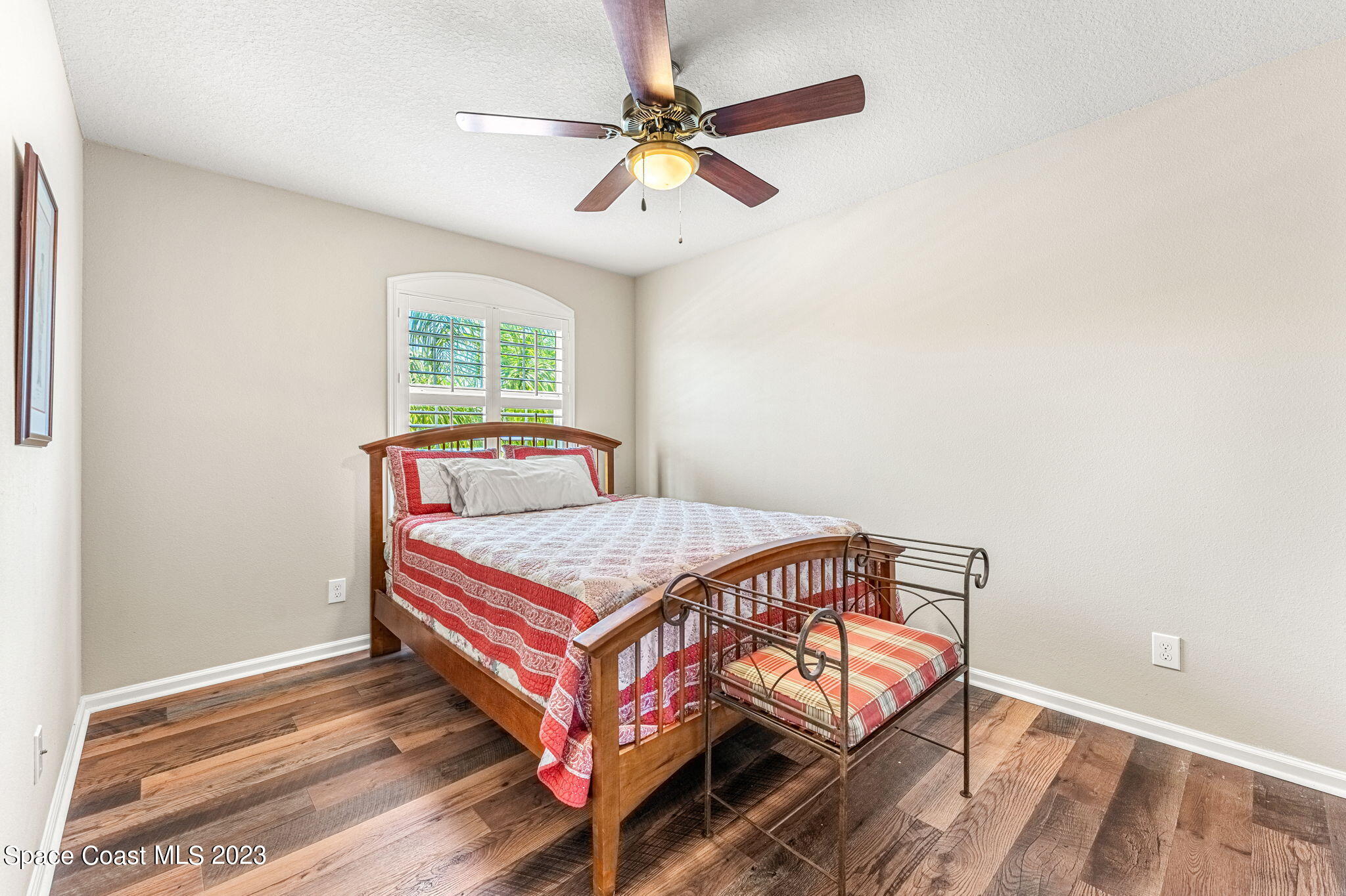 3310 Titanic Circle Indialantic, FL 32903 - Photo 12 of 25 a bedroom with a bed and a chandelier