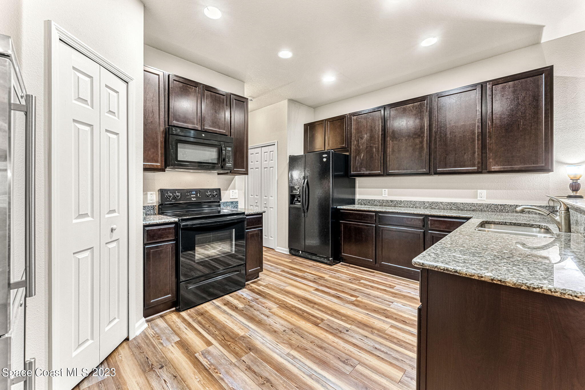 3310 Titanic Circle Indialantic, FL 32903 - Photo 5 of 25 a kitchen with a refrigerator stove and sink