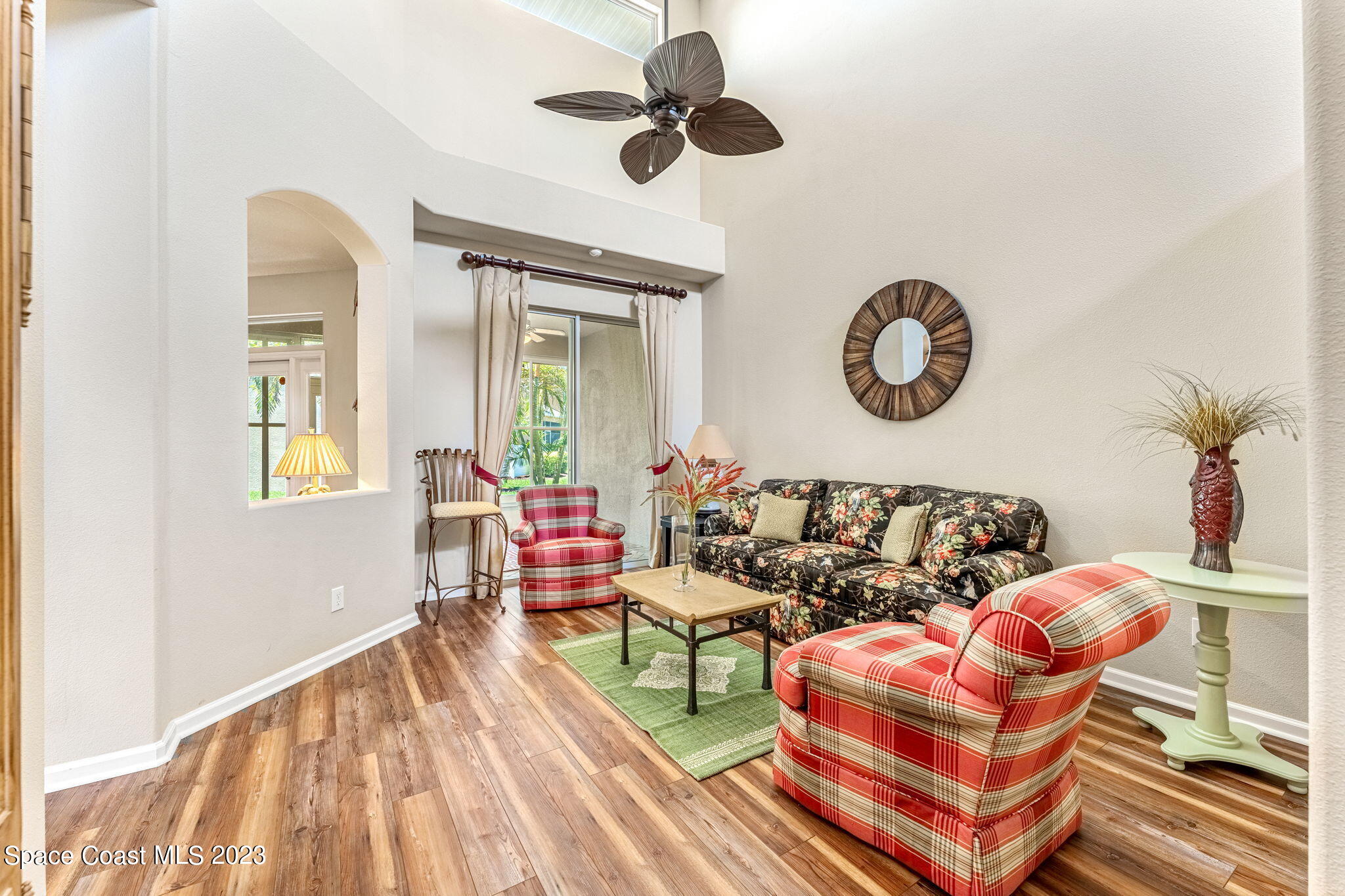 3310 Titanic Circle Indialantic, FL 32903 - Photo 7 of 25 a living room with furniture a clock and a window