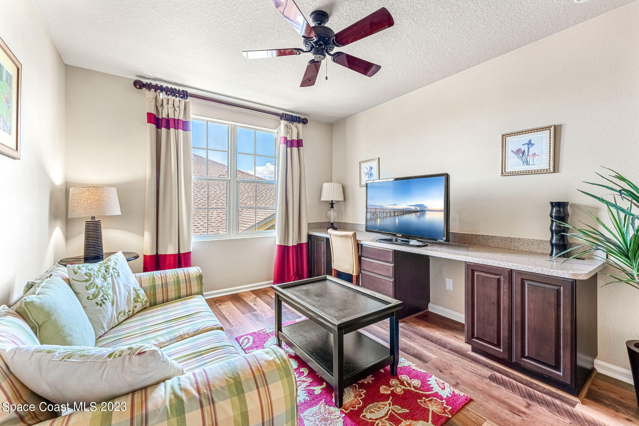3310 Titanic Circle Indialantic, FL 32903 - Photo 9 of 25 a living room with furniture and a flat screen tv