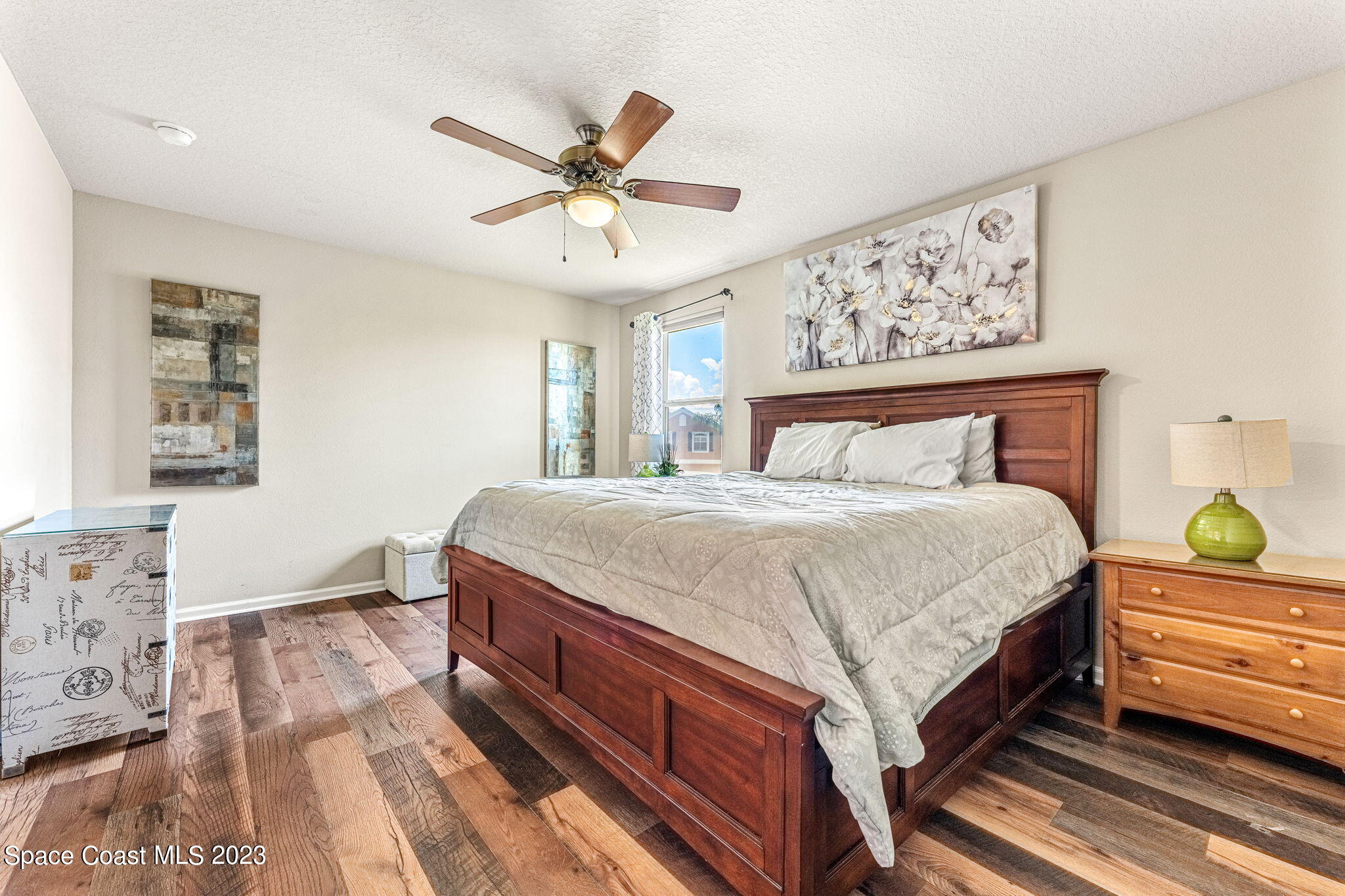 3310 Titanic Circle Indialantic, FL 32903 - Photo 10 of 25 a bedroom with a bed and a chandelier