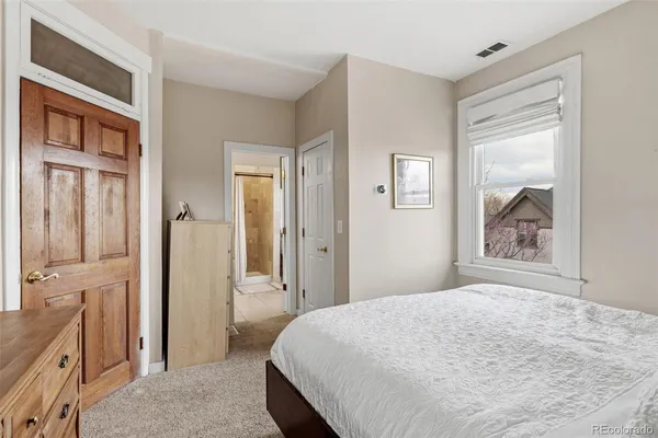 a spacious bathroom with a toilet sink and mirror