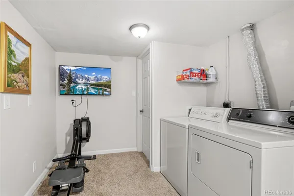 a view of an empty room with closet and a window