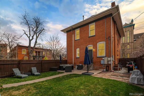 a view of backyard of house with outdoor seating