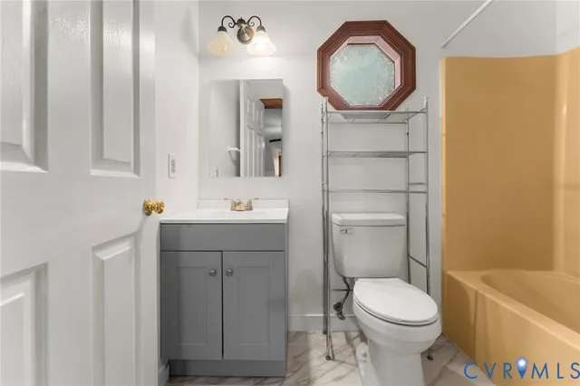 a bathroom with a toilet a sink and a mirror