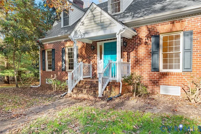 a view of a house with a yard and sitting area