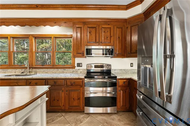 a kitchen with a stove a sink and a refrigerator