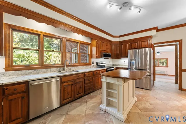 a kitchen with a sink refrigerator and microwave