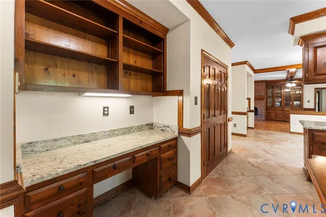 a bathroom with a granite countertop toilet sink and mirror