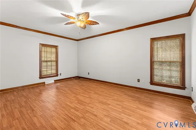 wooden floor in an empty room with a window