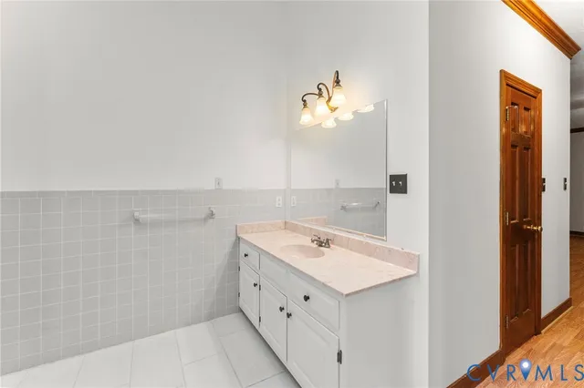 a bathroom with a sink a vanity and a mirror