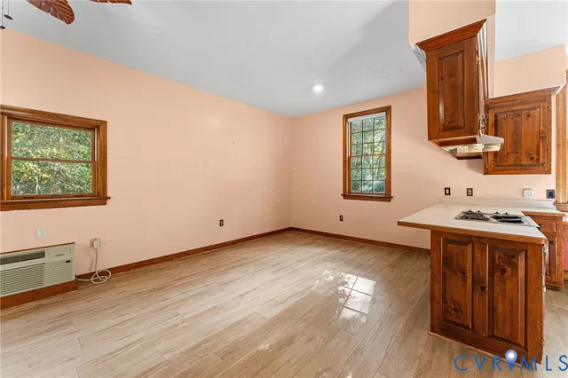 a kitchen that has a microwave and wooden floor