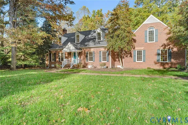 a front view of a house with a yard and trees