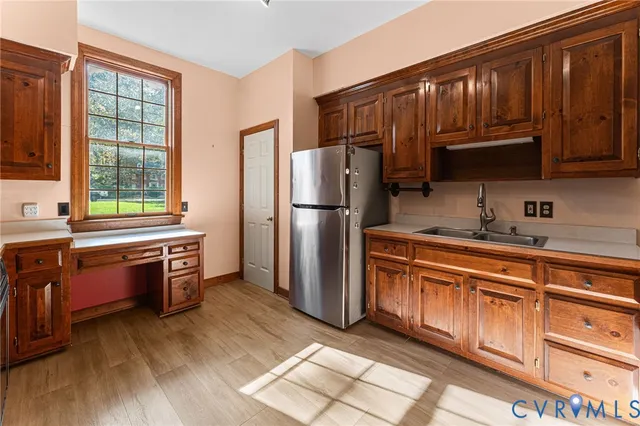a kitchen with stainless steel appliances granite countertop a refrigerator a stove a sink and dishwasher