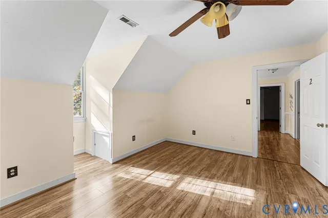 a view of a room with wooden floor and white walls