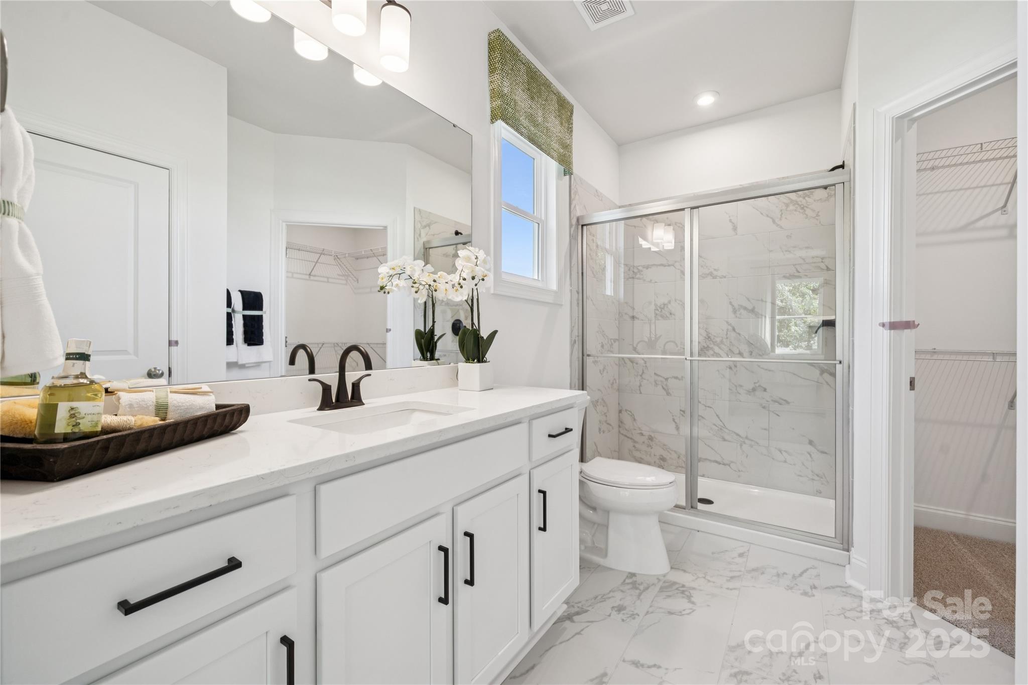 136 Balboa Street Matthews, NC 28104 - Photo 28 of 47 a bathroom with a double vanity sink toilet and shower