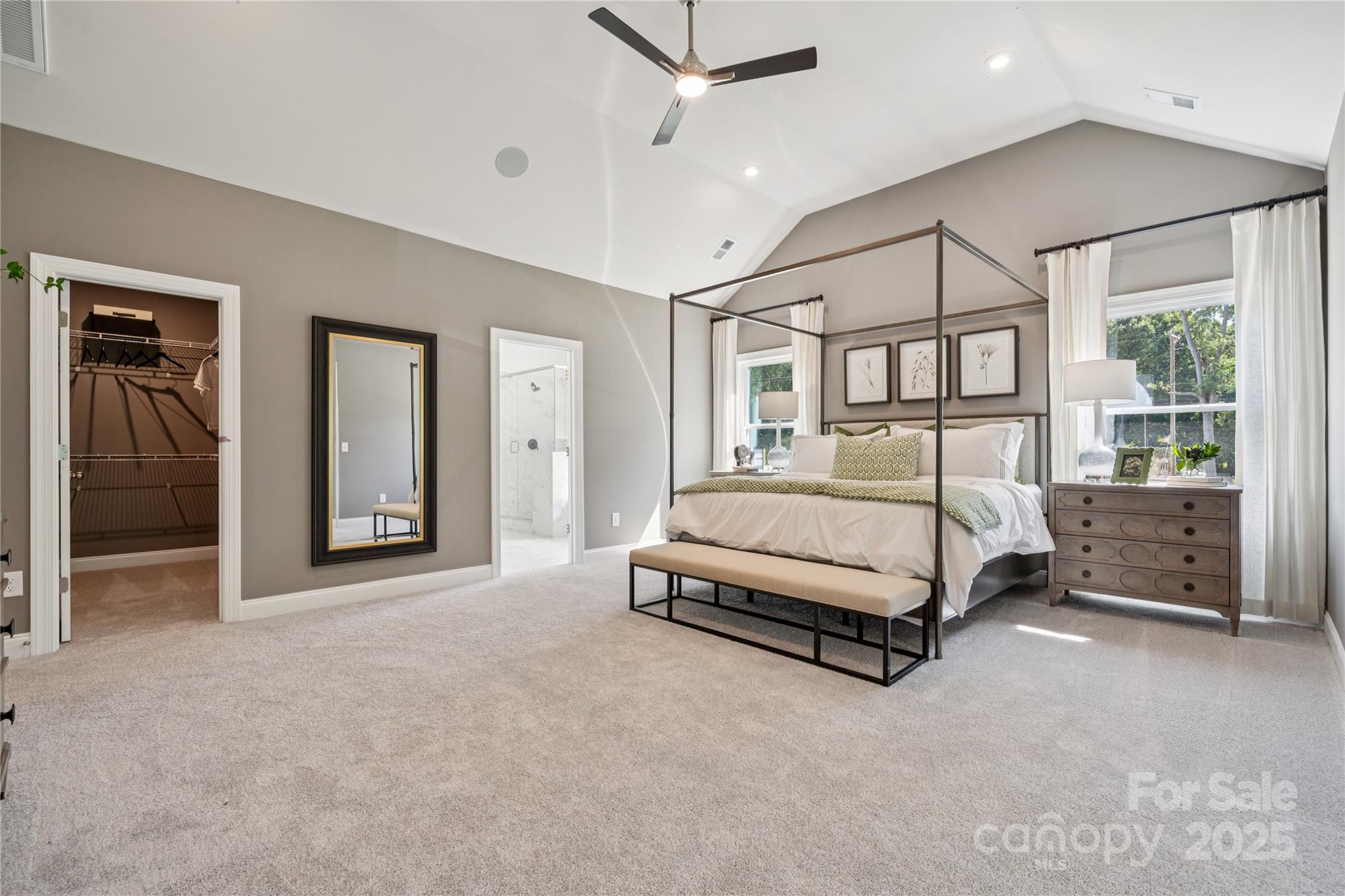 136 Balboa Street Matthews, NC 28104 - Photo 6 of 47 a spacious bedroom with a bed a table and large mirror