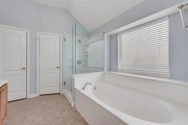 a bathroom with bathtub and a shower