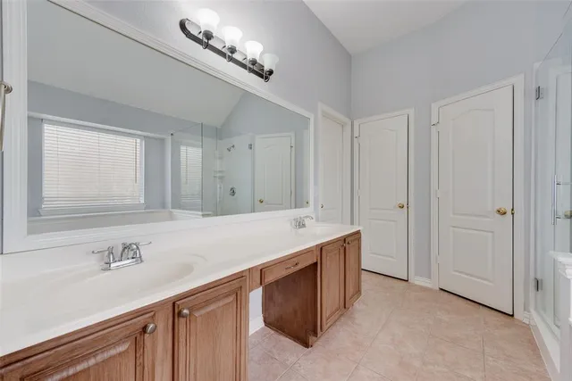 a bathroom with a sink double vanity and a mirror