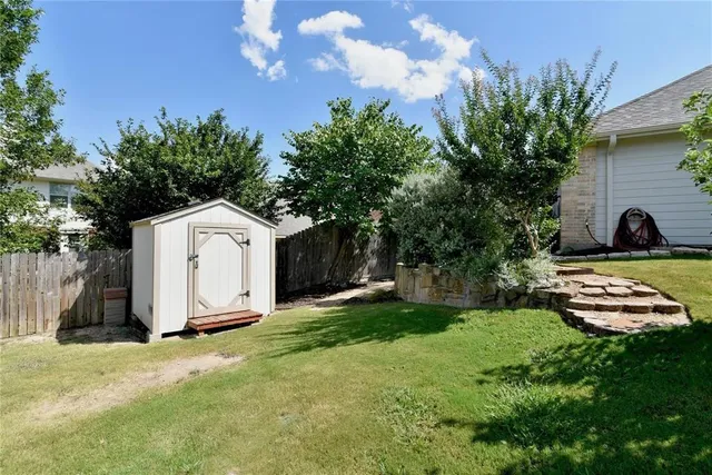 a view of a white house with a yard