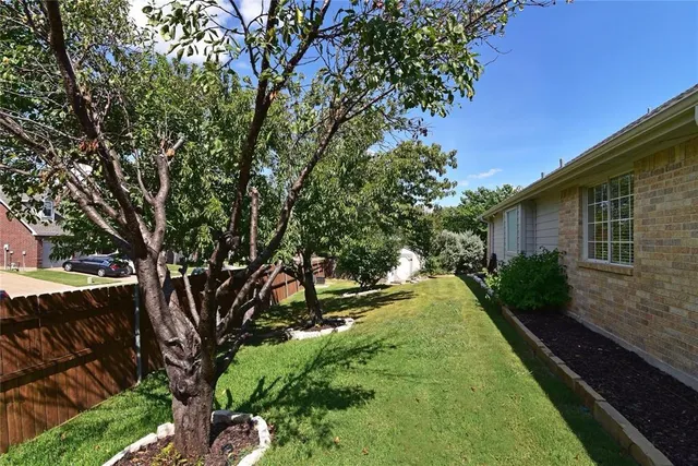 a view of an house with backyard space and garden