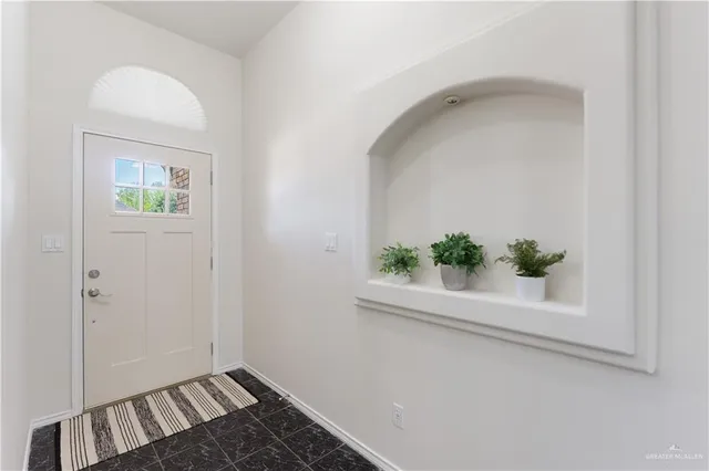 a view of an entryway with wooden floor