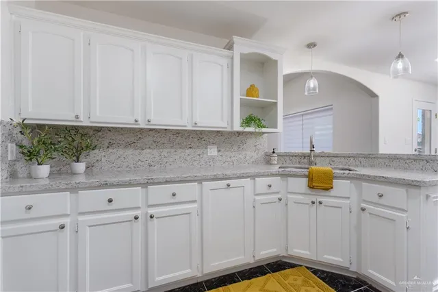a view of a kitchen with granite countertop cabinets