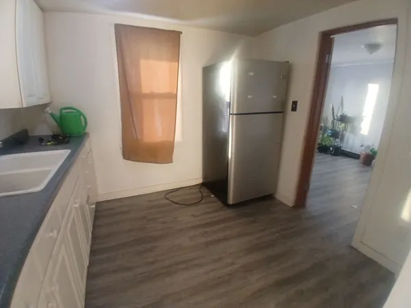 a view of hallway with wooden floor and stairs