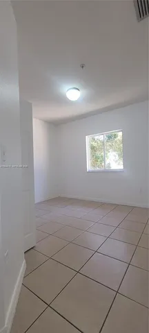 a view of an empty room and a window