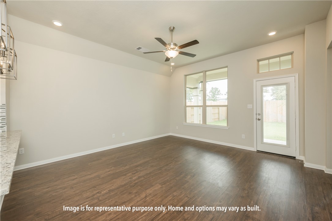 2422 Rooke Road Bryan, TX 77807 - Photo 12 of 12 an empty room with wooden floor fan and windows