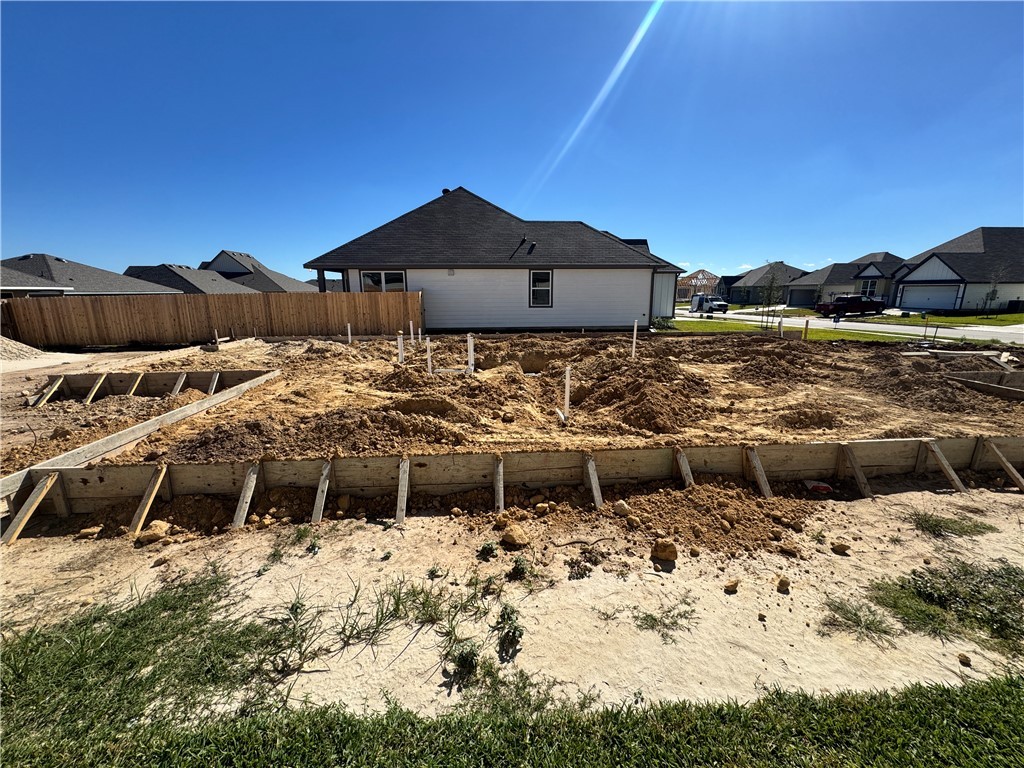 2422 Rooke Road Bryan, TX 77807 - Photo 4 of 12 a view of a lake with lawn chairs under an umbrella